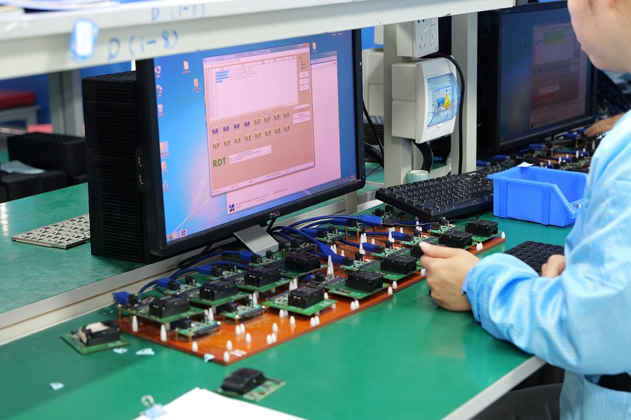 Engineers performing NAND flash component testing during SSD manufacturing