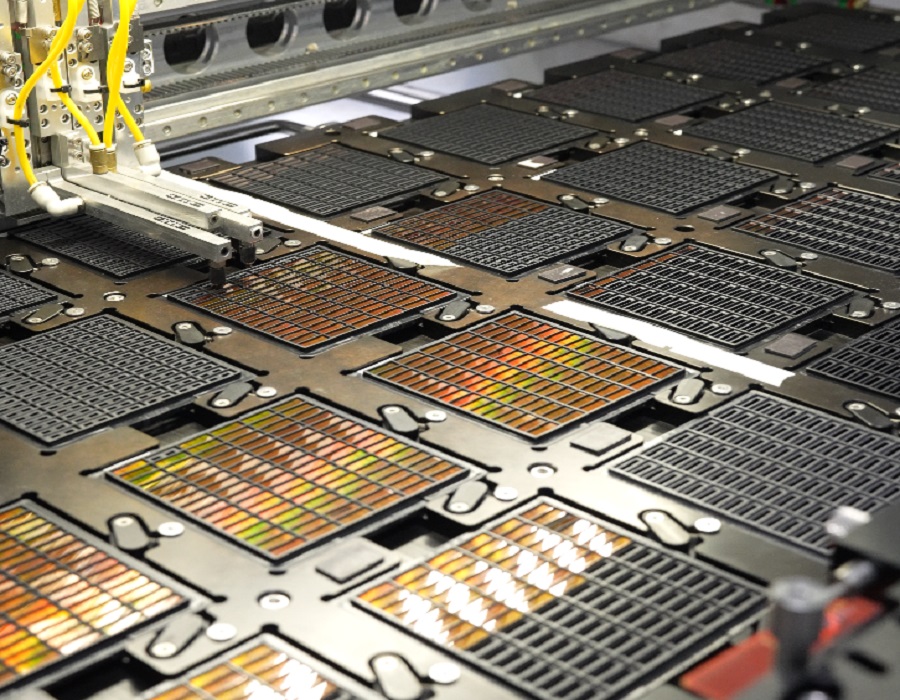 SMT pick and place machine assembling components on SSD PCB